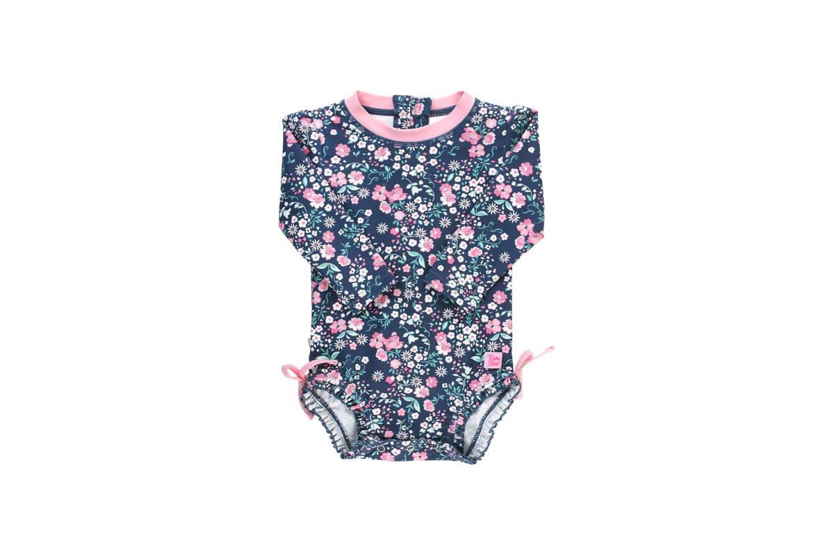 Image of a baby's one piece outfit. This outfit has a navy background with little pink flowers, a pink collar and a little bow on the top of each leg hole.