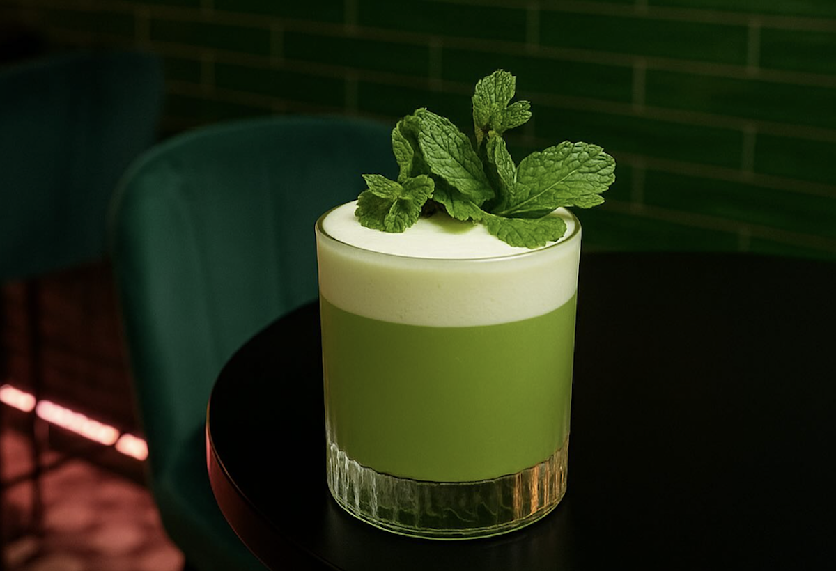 A green drink with mint on top.