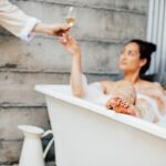 woman in spa bath having champagne