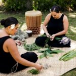 Women weaving leis