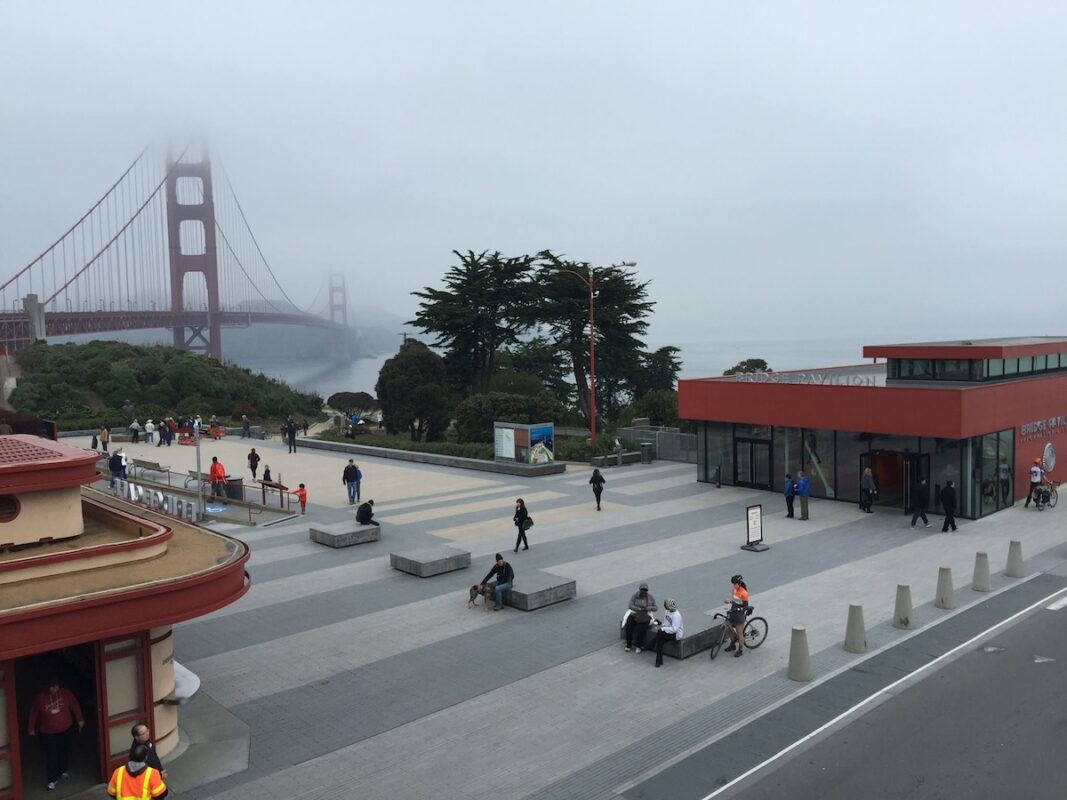 Paved walkway at the Golden Gate Bridge Visitor Center, and the bridge covered in heavy fog