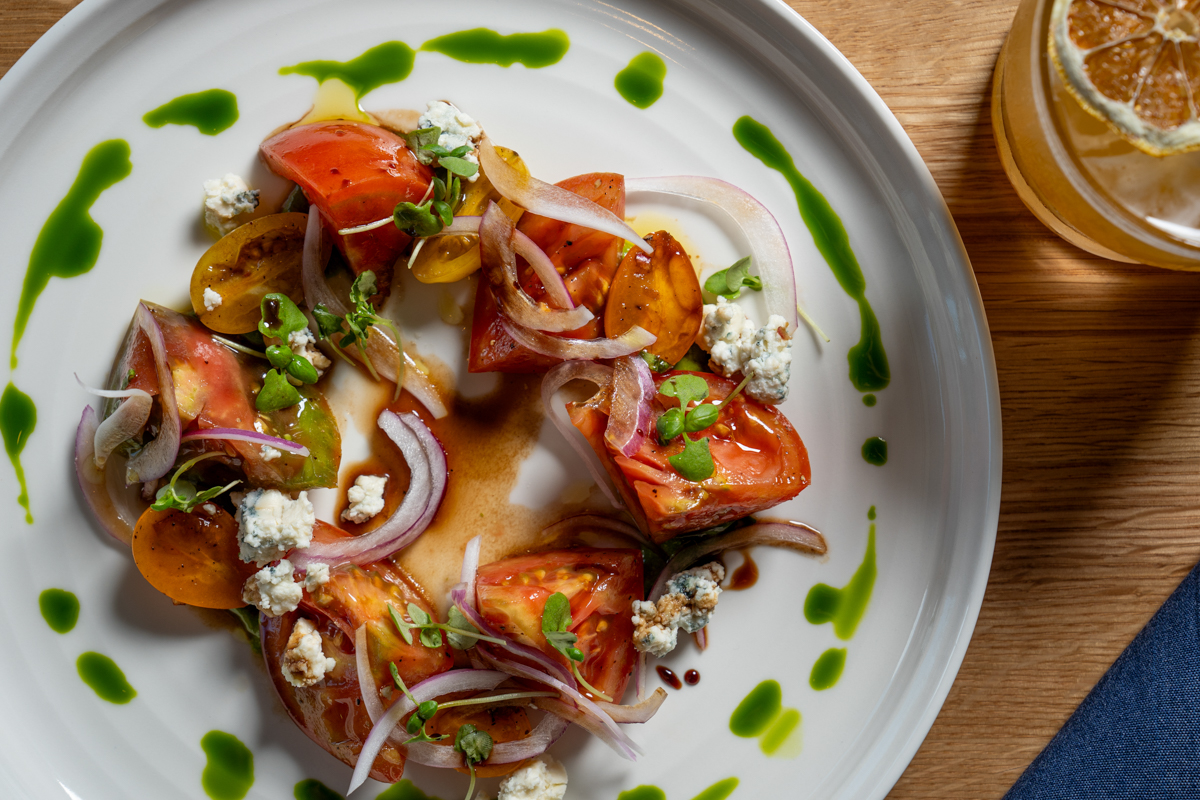 Tomato salad on a plate at Lana San Diego