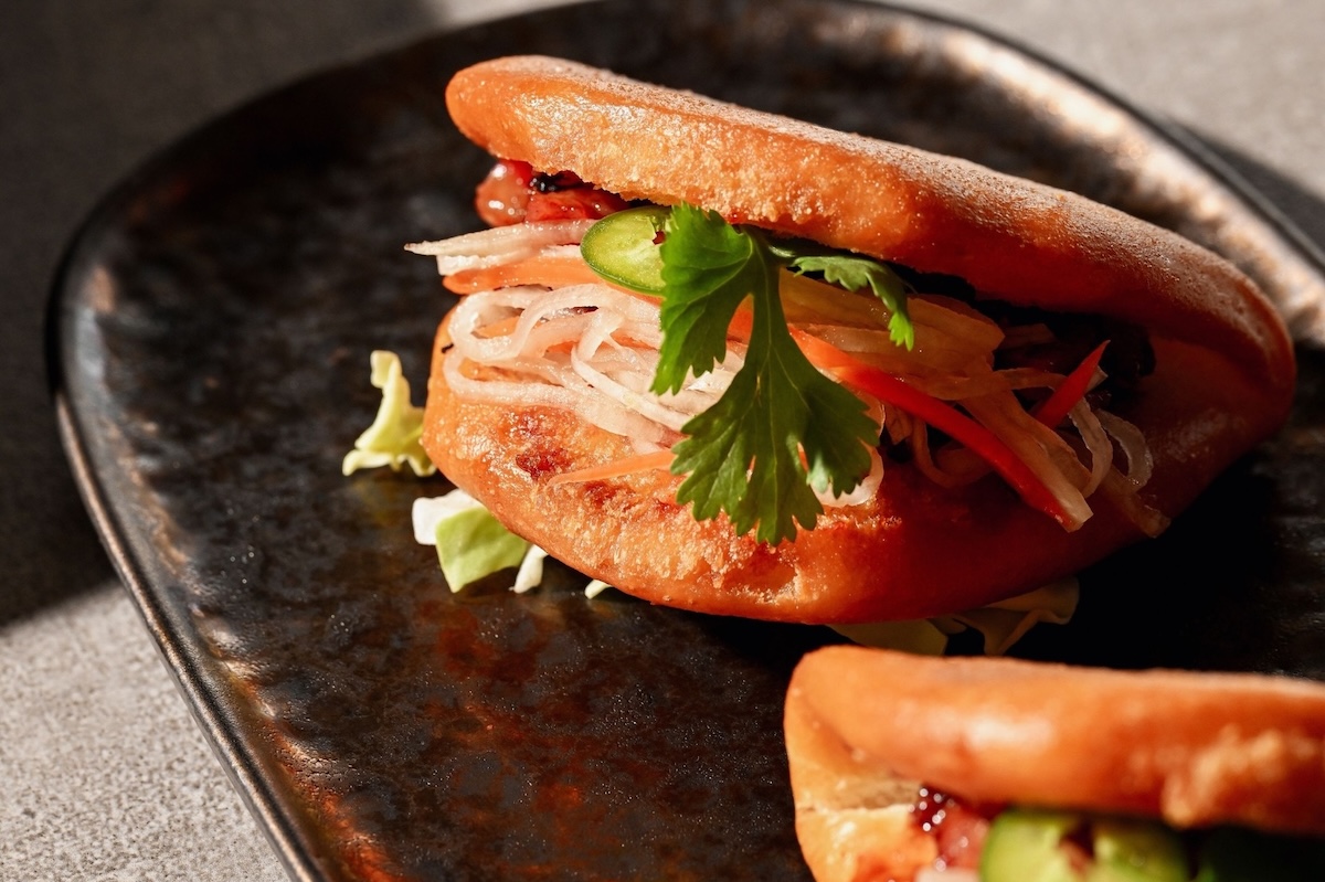 Bao buns with sliced veggies and cilantro.