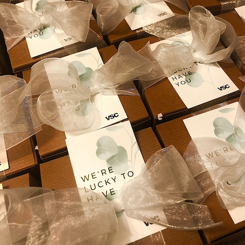 Rows of brown boxes with a label and ribbon.