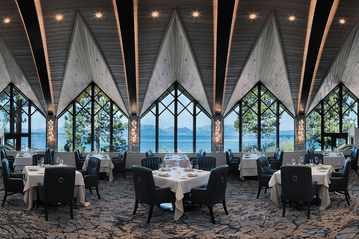 A cozy dining room at the Tahoe lodge, showcasing wooden furnishings and panoramic views of the surrounding nature.