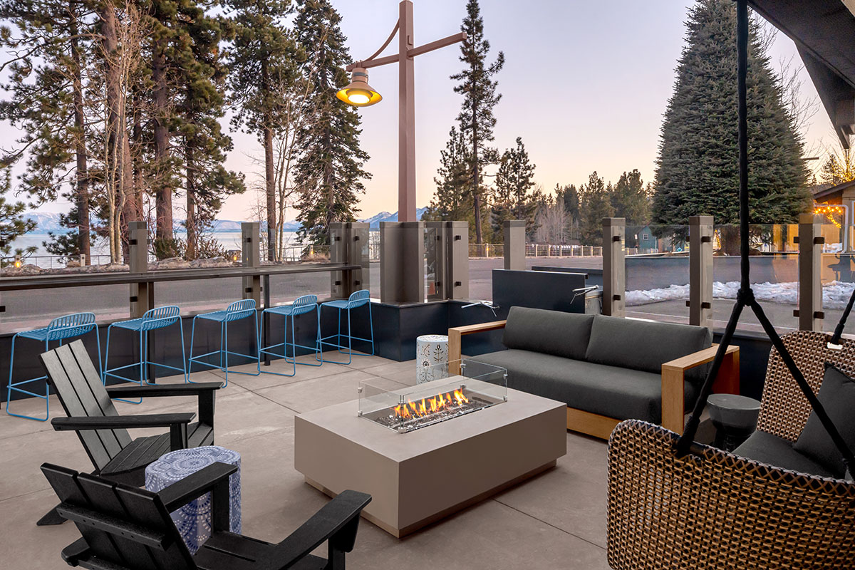 Outdoor patio featuring a cozy fire pit surrounded by comfortable chairs for relaxation.
