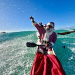 Santa canoeing in Hawaii