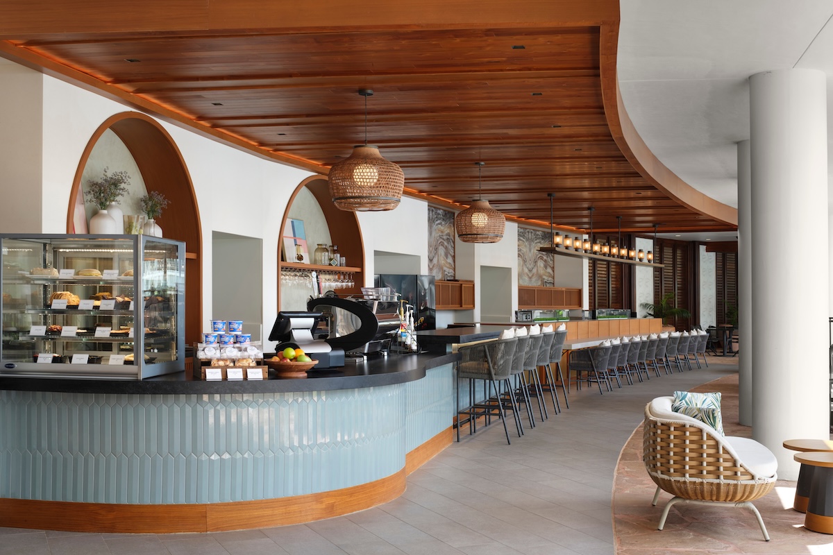 The shot of a coffee bar with blue tile and wood details.