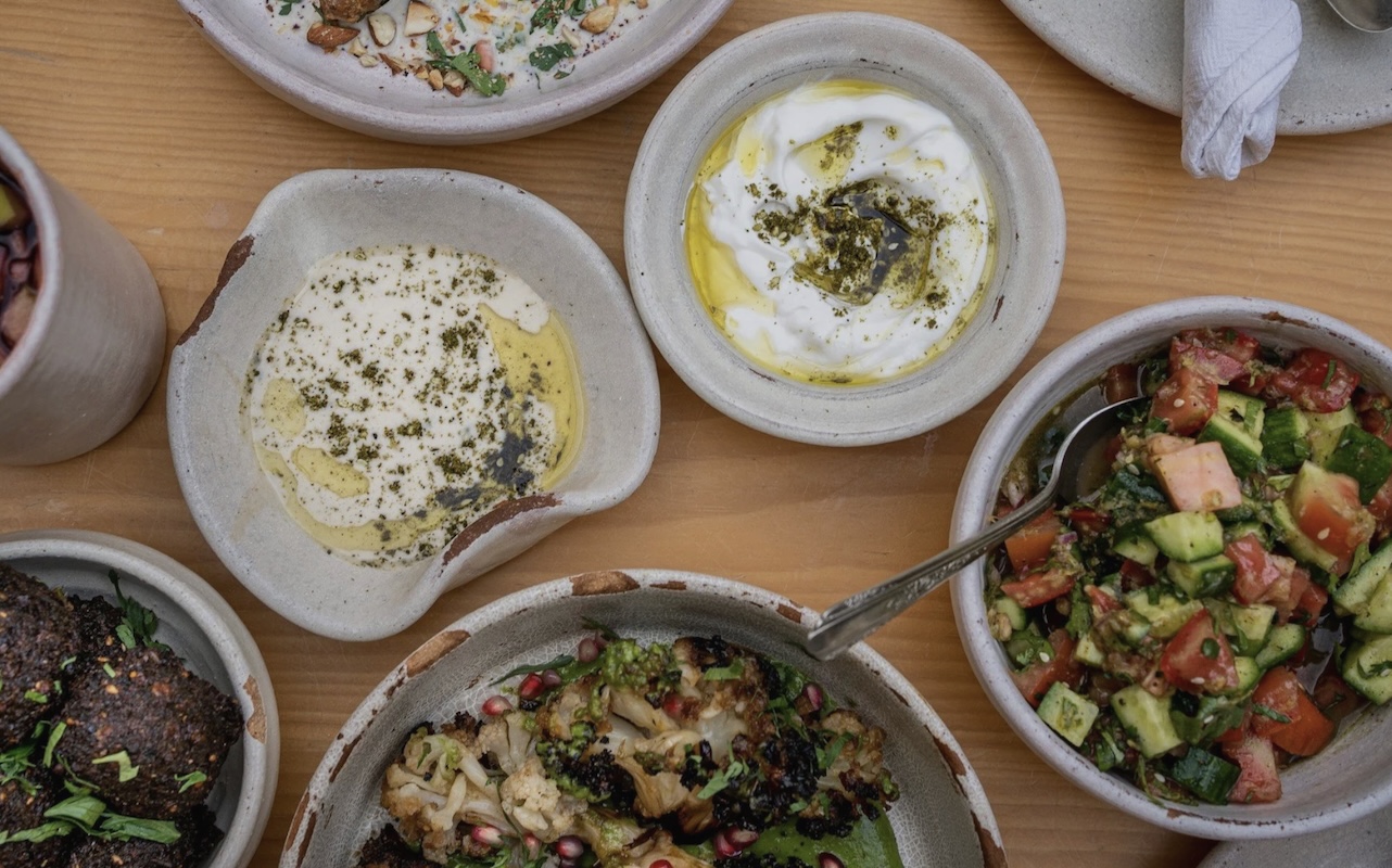 An aerial shot of plates of food and dips.