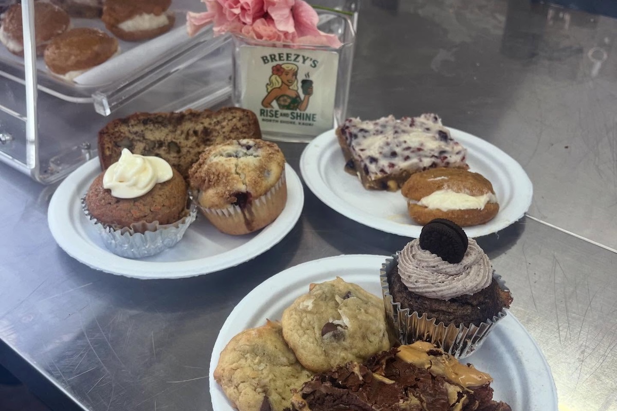 Paper plates with various pastries including cookies and cupcakes.