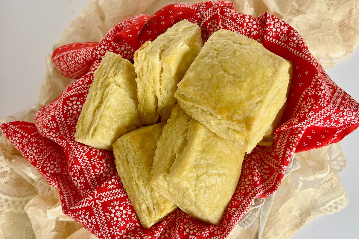 A few biscuits sit on top of a red and white patterned cloth.
