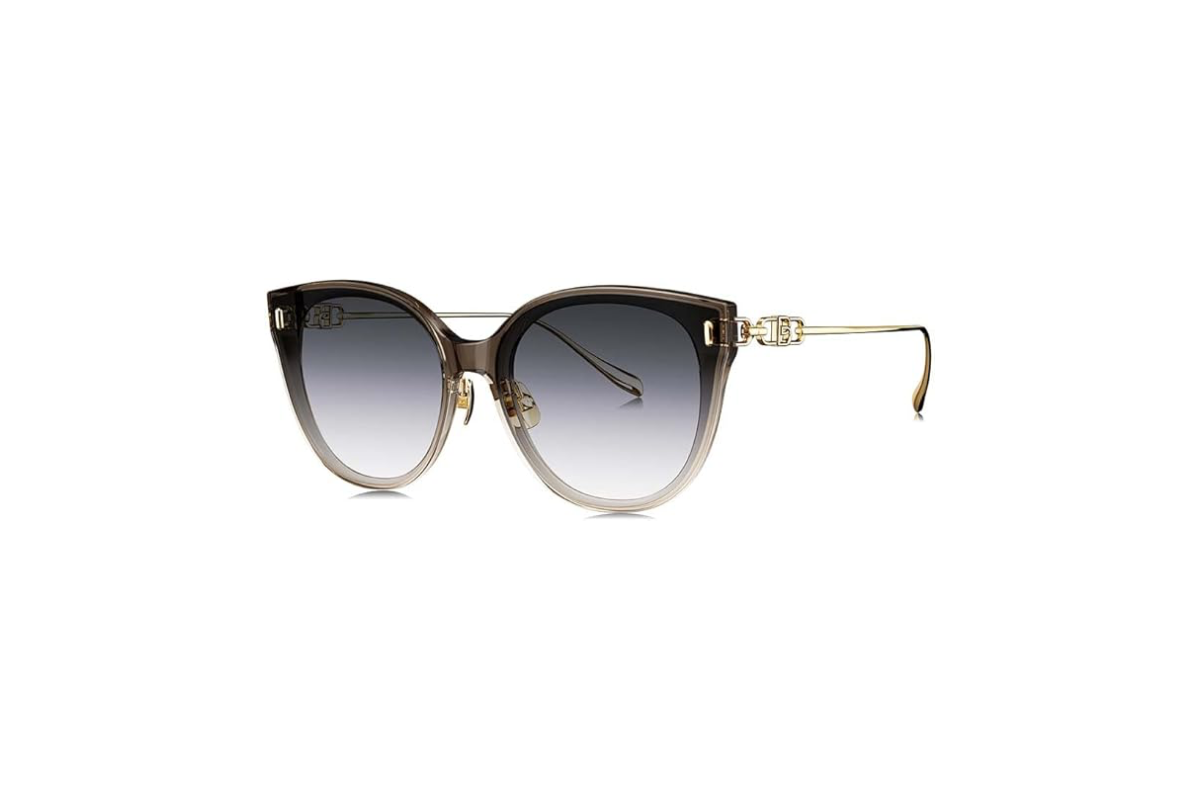 This image shows a pair of cateye sunglasses with oversized lenses in a gradiant grey and gold metal frames.