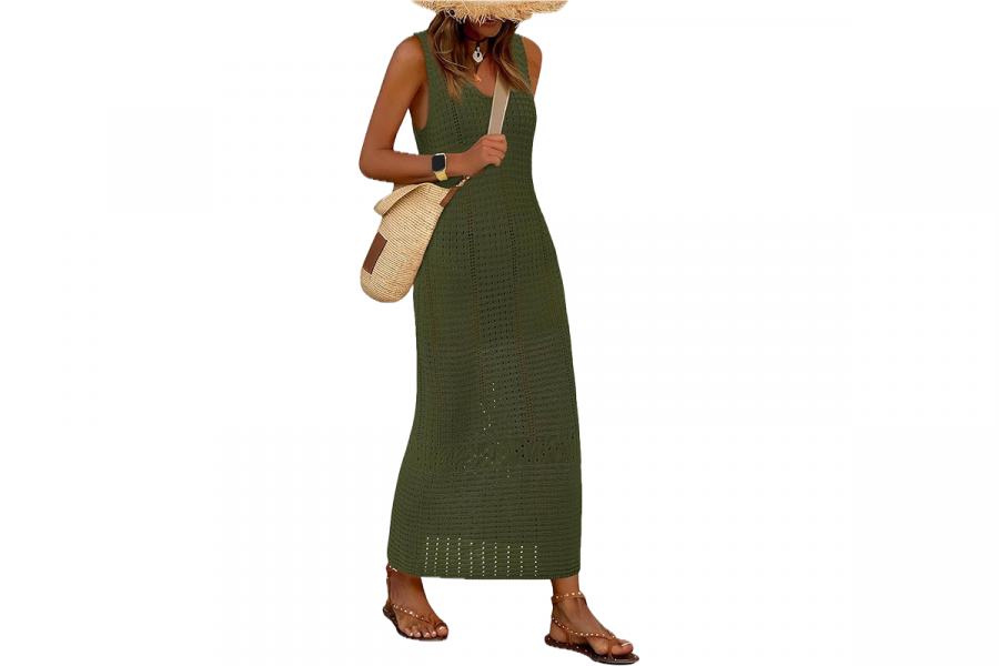 A woman wearing a long, sleeveless, green, crochet style maxi dress.