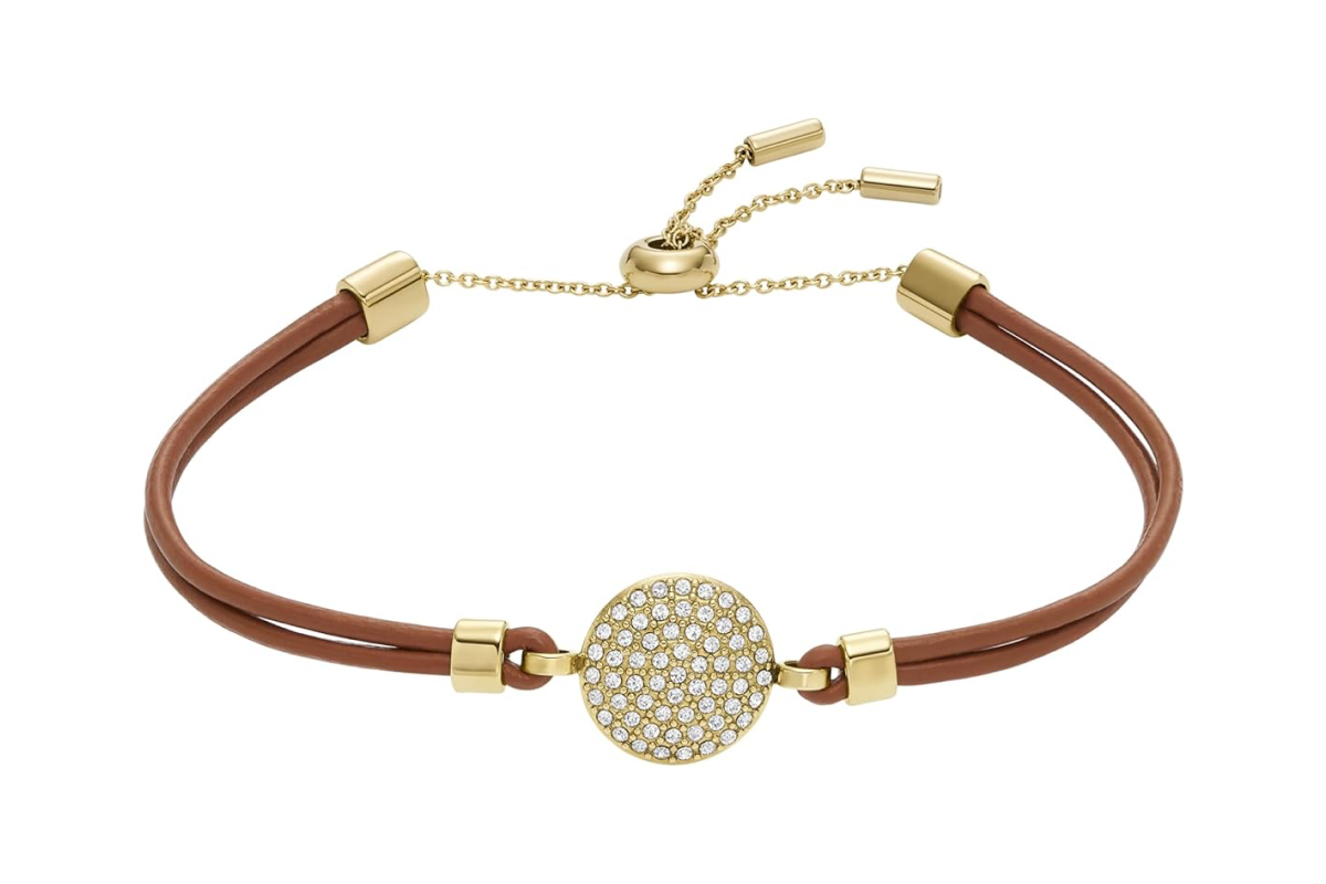 This image features a brown leather bracelet, with gold trim and a crystal encrusted disc.