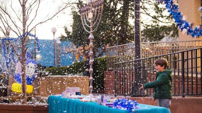 A child enjoys the Giant Menorah Lighting and Gelt Drop in Downtown San Rafael