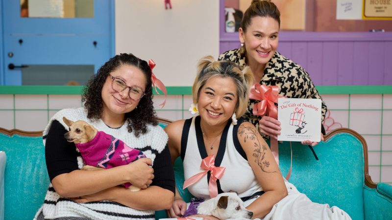 The cast of the Gift of Nothing pose with a dog