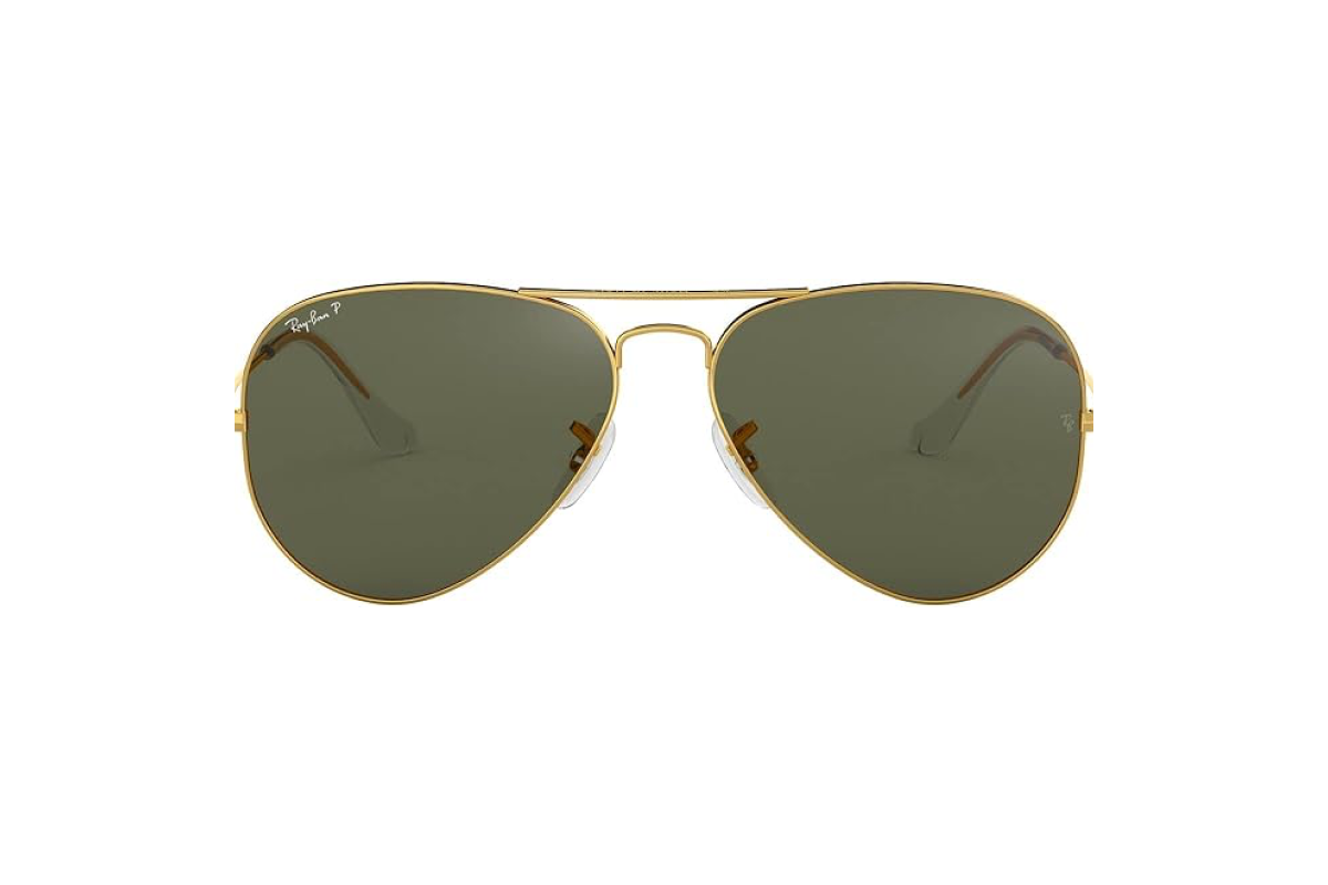A pair of aviator style sun glasses with a gold rim and a dark lens.