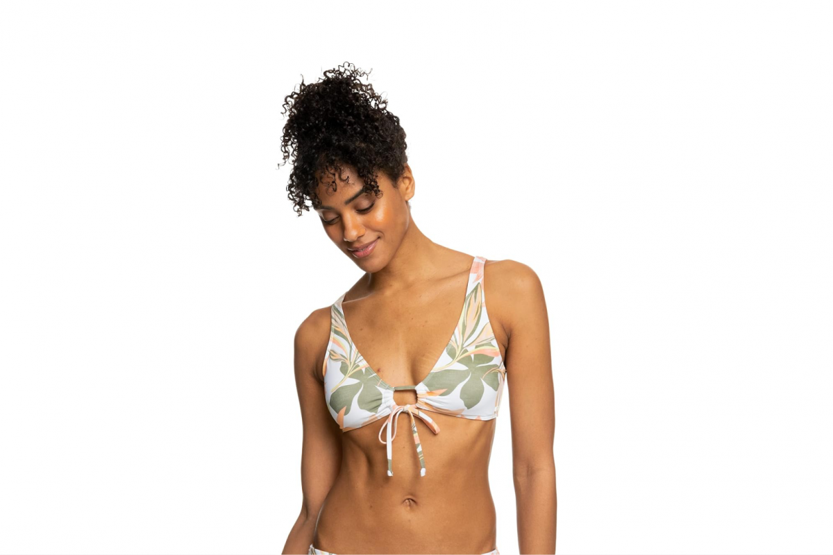 This image features the upper body of a woman wearing a green, pink and white floral bikini top