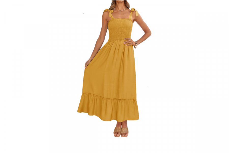 A woman wearing a long, yellow dress with a ruffled hem and tie straps.