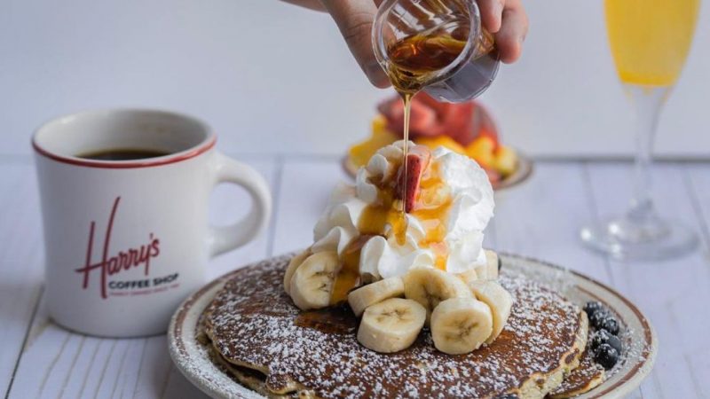 Syrup is poured over pancakes at Harry's coffee shop in San Diego