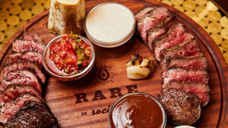 A plate of rare steak laid out on a platter from Rare Society