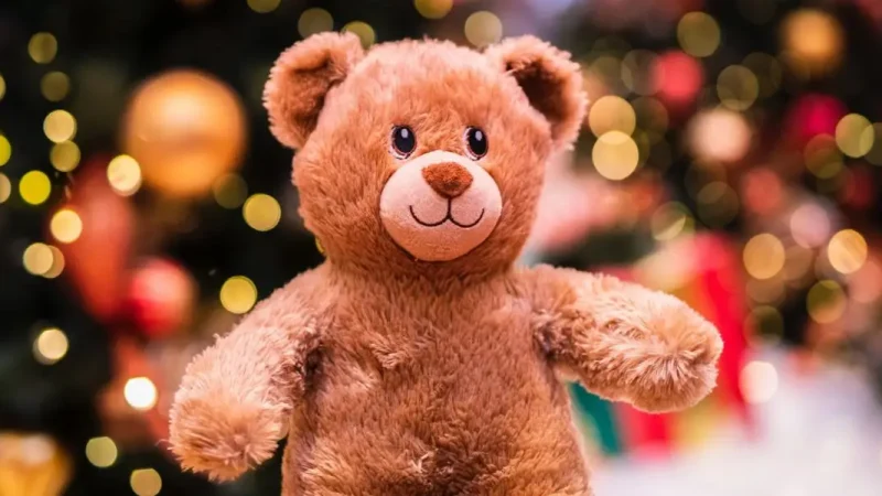 Teddy bear in front of Christmas lights